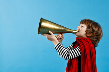 Cute boy in mime costume shouting in megaphone on light blue background, space for text. Surprise...