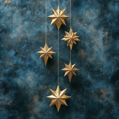 Golden Decorative Stars Hanging Against a Textured Dark Blue Background