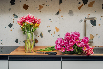 The process of caring for flowers. Trimming tulips