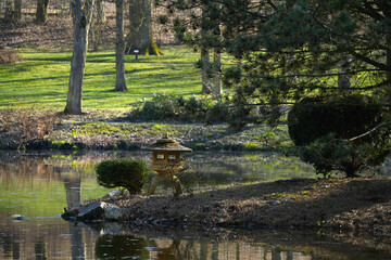 Beautiful spring green park scenery with quiet pond