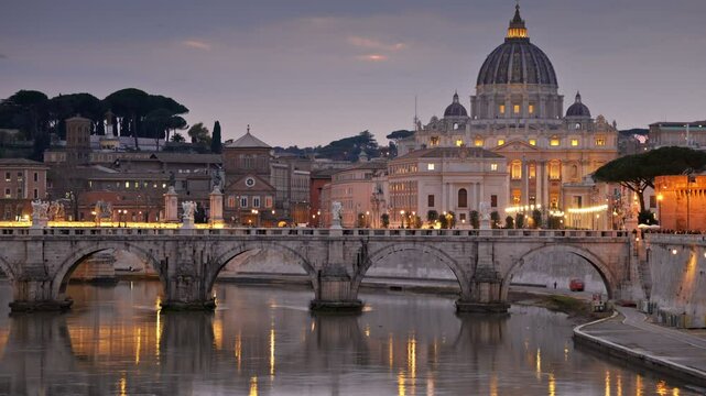 Zoom out shot of St. Peter's Basilica and Sant Angelo Bridge in Vatican, Rome, Italy. Birds fly at sunset against the backdrop of evening Rome with city lights. HDR shot