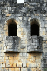 Fototapeta premium Medieval stone wall with towers and loopholes showcasing defensive architecture