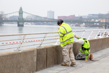 Workers in High Visibility Clothing by London Riverside in Hammersmith, London UK

