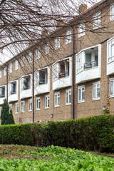 Fototapeta premium Exterior View of Brick Apartment Building in London Neighborhood. Vertical photo