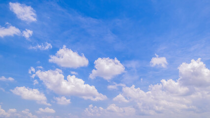 Obraz premium clear blue sky background,clouds with background, Blue sky background with tiny clouds. White fluffy clouds in the blue sky. 