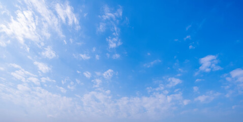 Fototapeta premium clear blue sky background,clouds with background, Blue sky background with tiny clouds. White fluffy clouds in the blue sky. 