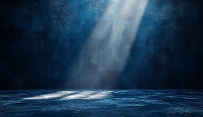 Spotlight shines on a dark blue stage floor; a background for display or artwork