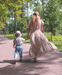 mother and daughter walking in park