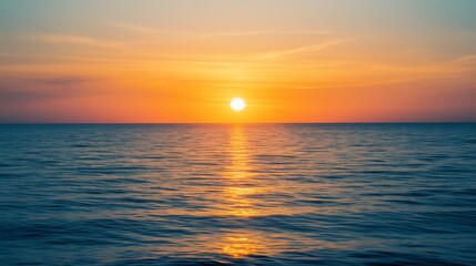 Obraz premium A mesmerizing sunset over the vast ocean, with golden hues reflecting on the water and a gentle gradient of colors fading into the horizon.