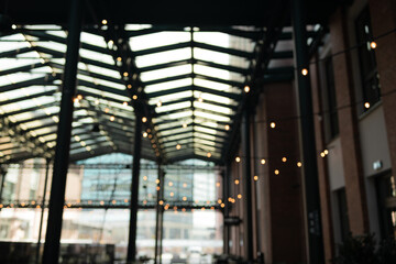 Festive, Christmas, New Year background. Evening. Night. Homely, cozy background. Abstract background of a night view and golden garlands. Bokeh. 