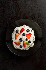 Meringue dessert with fresh berries. Light, crispy, and sweet with a delicate texture and vibrant...