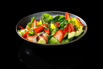 A fresh fruit and greens salad with strawberries, citrus, and avocado. Restaurant-style...