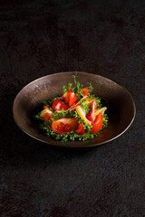 A fresh and vibrant vegetable salad, elegantly plated in a restaurant-style presentation.