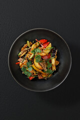A fresh and vibrant vegetable salad, elegantly plated in a restaurant-style presentation.