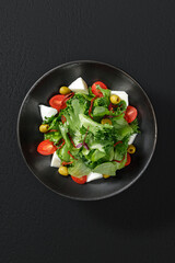 Fresh vegetable salad with feta cheese, featuring tomatoes, cucumbers, bell peppers, and red onions. A vibrant and healthy dish.