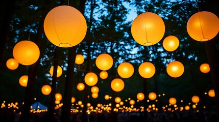 Summer concert night atmosphere concept. Lanterns glowing in a forest during twilight, creating a magical ambiance.