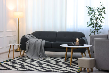 Comfortable couch, armchairs and coffee table in living room. Interior design