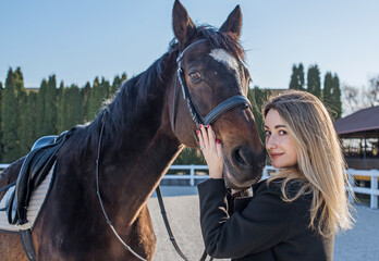 Fototapeta premium Woman in old money style with a horse. Quiet lifestyle. Lady have a time for riding. Horses concept