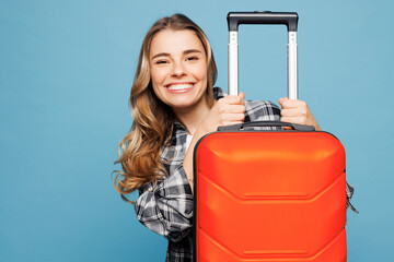 Close up traveler woman wear grey casual clothes hold suitcase bag look camera isolated on plain...