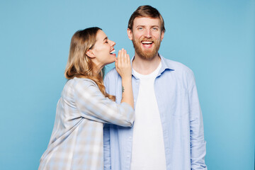Young couple two friends family man woman wear shirt casual clothes together whispering gossip and...
