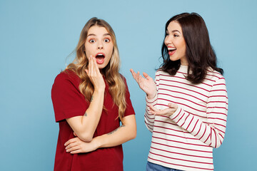 Side view young couple two friends women wearing red casual clothes together gossip and tells...