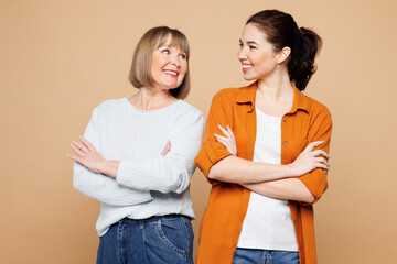 Elder smiling parent mom 50s years old with young adult daughter two women together wear casual...