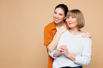 Elder fun parent mom 50s years old with young adult daughter two women together wear casual clothes...