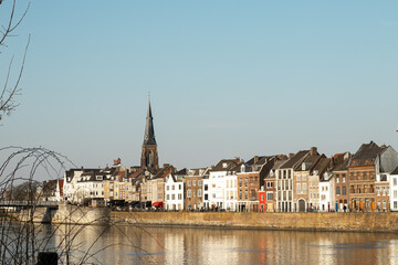 A scenic European city by the river with charming architecture and a canal flowing through, peaceful and picturesque atmosphere.