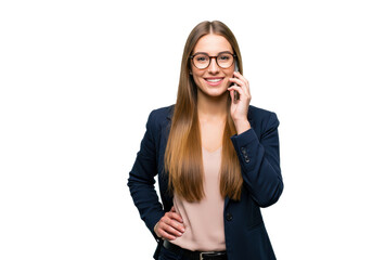 Fototapeta premium A young businesswoman with stands confidently with one hand on her hip while talking on her smartphone isolated on transparent background