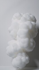 Abstract image featuring dense fluffy puffs of white smokefog on a white backdrop creating the illusion of moving smoke clouds