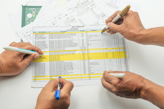 Engineer team assesses bill of material with detailed documentation and collaborative effort