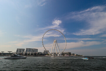 Dubai ferris wheel and city skyline from Jumeirah Beach. 2025