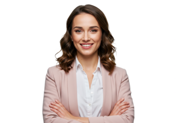 A smiling professional woman with wavy brown hair wearing a soft pink blazer stands with her arms crossed isolated on transparent background
