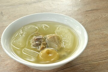 boiled winter melon pork bone with pickled lemon in clear soup on bowl