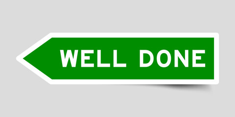 Green color arrow shape sticker label with word well done on gray background