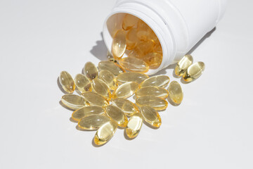 Omega 3, 6, 9 fish oil capsule, vitamin, nutritional supplement, from a medicine bottle on a white...