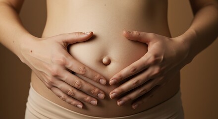 Pregnant Woman's Belly with Hands Forming Heart Shape, Close Up