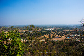 Obraz premium Aerial view landscape of rice field or paddy land and village countryside from viewpoint of Wat Khao Meng Amornmet Temple for thai people travelers travel visit at Pak Phraek in Kanchanaburi, Thailand