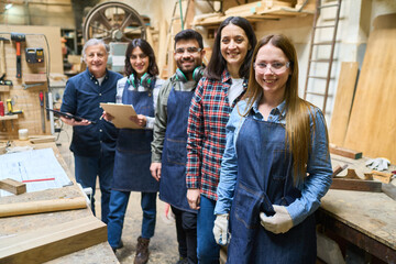 Diverse team of carpenters working together in a wood workshop
