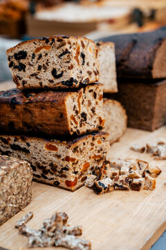 Delicious bread in fair with dried fruits and raisins on a wooden table with a sweet, baked, and healthy snack vibe from bakery