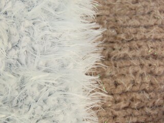 Closeup of light gray and beige fluffy synthetic knitting. Knitting textures.