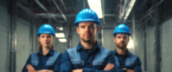 Blurred background featuring a row of electricians in blue safety helmets, arms crossed, symbolizing strength, discipline, and industry expertise