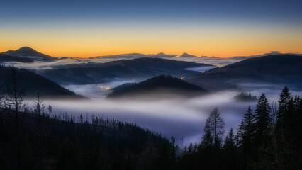 Fototapeta premium fog over the Liptov village of Velke Borove before sunrise