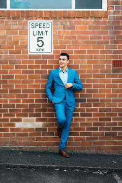 man leaning against wall with speed limit