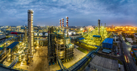 Panoramic view of illuminated chemical plant and oil refinery at night