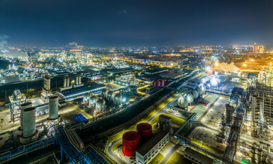 Fototapeta premium Aerial view of illuminated industrial complex at night