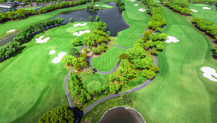 Aerial view of beautiful golf course with trees and river