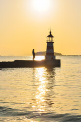 One Asian woman enjoying beautiful sunset at  Xunliao Bay coastline in Huizhou, Guangdong province, China, in January winter