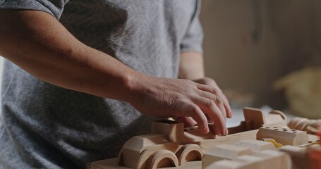 A Craftsman is skillfully working with wooden toys, showcasing their artistry and creativity