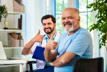 Fototapeta premium Indian Doctor, elderly patient share a thumbs-up in a cozy clinic, celebrating healthcare success